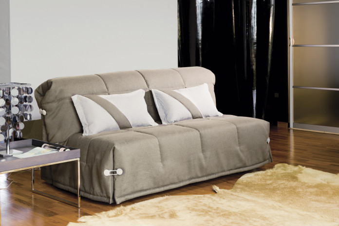 Ginger fold out sofa bed with headboard completed with lumbar cushion with decorative diagonal stipes.