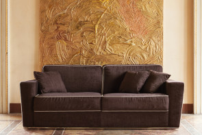 Retrohs wheeled sofa bed with contrasting edging that enhance the armrests flared line.