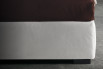 Detail of the upholstered bed-frame with slightly rounded corners
