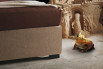 Detail of the slim bed-frame and of a wengé painted foot