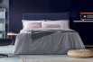 Upholstered double bed with quilted frame and headboard in a square pattern